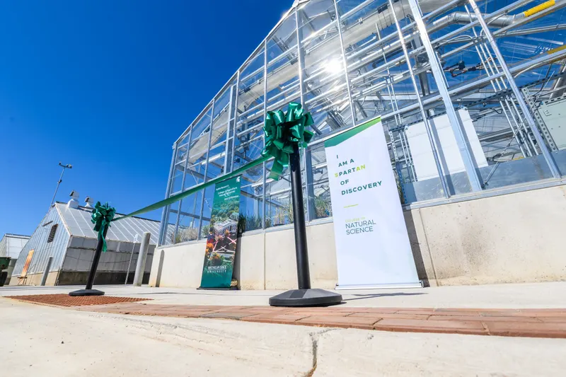 Two glass greenhouse structures at Michigan State University.